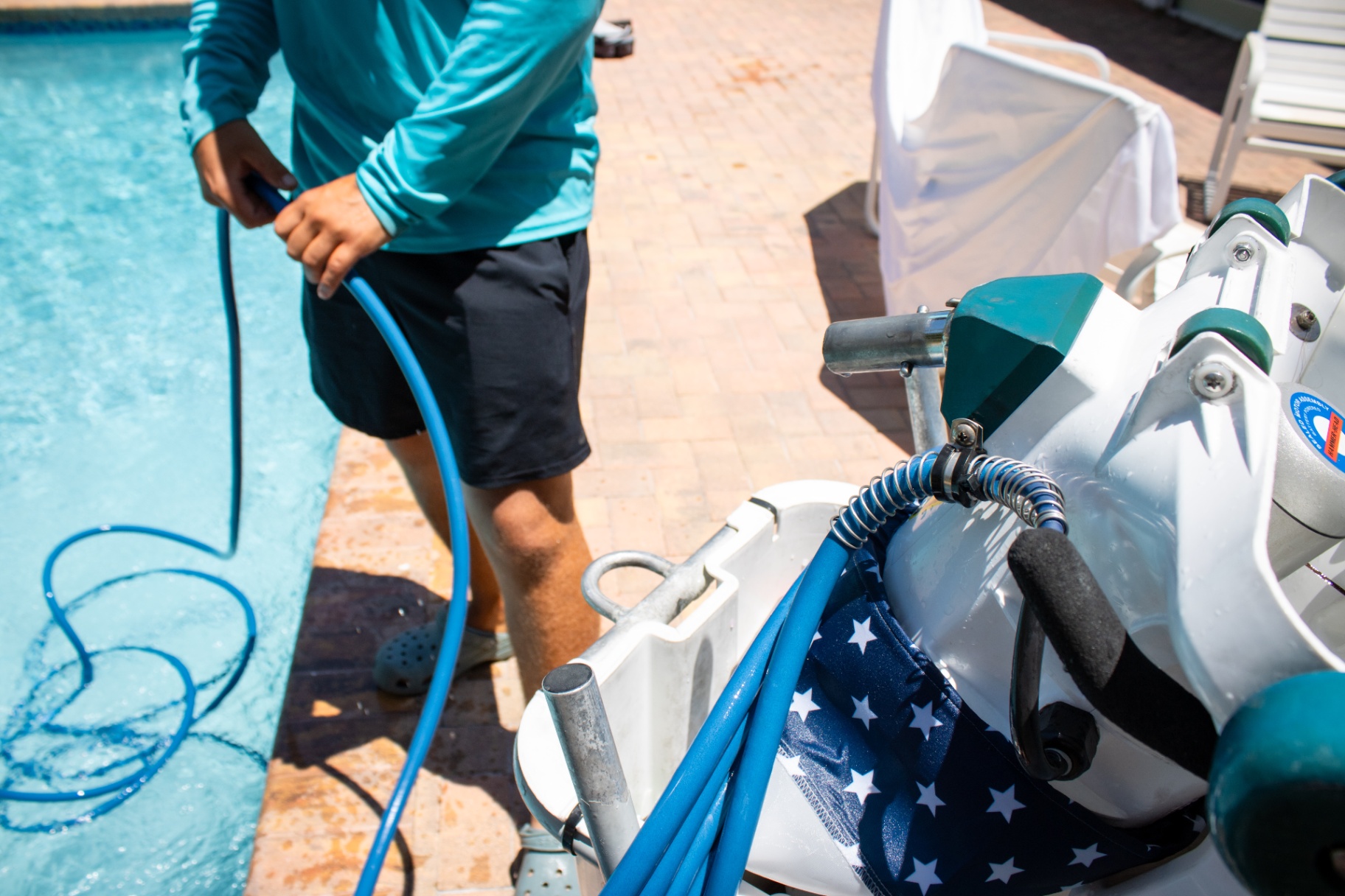 Riptide vacuum on site Pool technician deploying a Riptide pool vacuum hose for cleaning at a Palm Beach County home